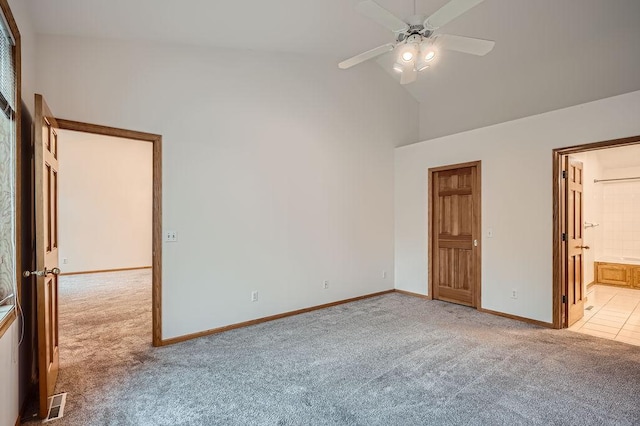 1584 126th Ln NW, Coon Rapids, MN 55448 - unfurnished bedroom featuring light carpet, high vaulted ceiling, connected bathroom, and a ceiling fan
