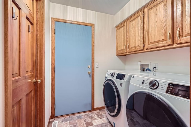 1584 126th Ln NW, Coon Rapids, MN 55448 - laundry room featuring independent washer and dryer, cabinet space, and stone finish flooring