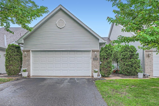 1584 126th Ln NW, Coon Rapids, MN 55448 - garage featuring asphalt driveway