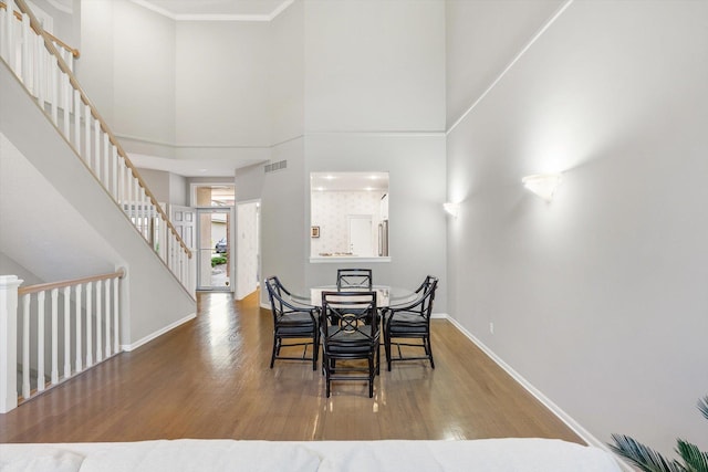 5555 70th St, Edina, MN 55439 - dining area with wood finished floors, baseboards, stairs, ornamental molding, and a high ceiling