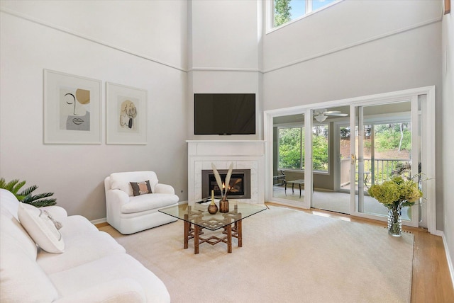 5555 70th St, Edina, MN 55439 - living area with wood finished floors, a tile fireplace, a high ceiling, and a ceiling fan