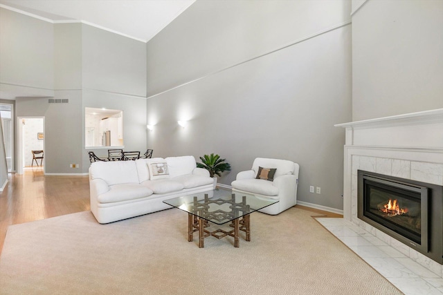 5555 70th St, Edina, MN 55439 - living area with ornamental molding, a fireplace, a high ceiling, baseboards, and wood finished floors