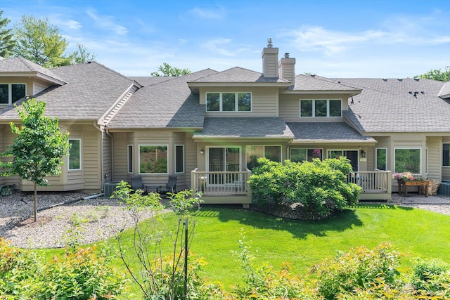 5555 70th St, Edina, MN 55439 - view of front of house featuring a chimney, a front lawn, a deck, roof with shingles, and central AC