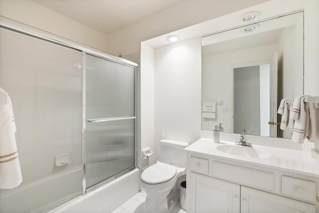 5555 70th St, Edina, MN 55439 - bathroom featuring vanity, toilet, and shower / bath combination with glass door