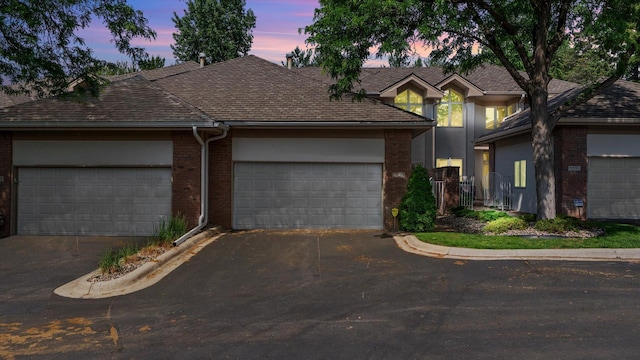 5555 70th St, Edina, MN 55439 - traditional-style home featuring brick siding, asphalt driveway, and a garage
