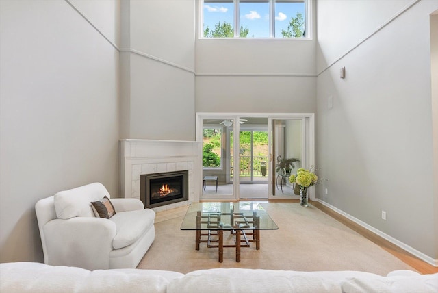 5555 70th St, Edina, MN 55439 - living room featuring a towering ceiling, a tile fireplace, and baseboards