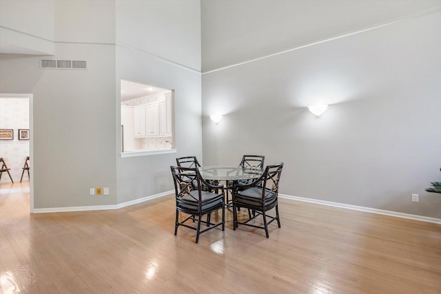 5555 70th St, Edina, MN 55439 - dining area featuring light wood finished floors, baseboards, and a towering ceiling