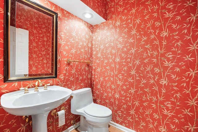 5555 70th St, Edina, MN 55439 - half bathroom featuring wallpapered walls and toilet