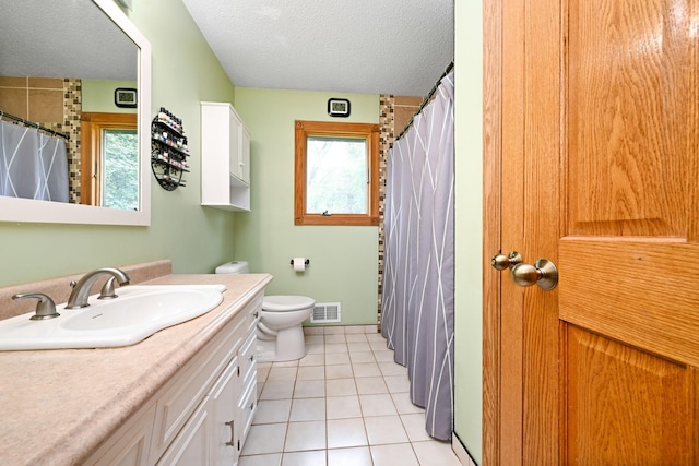 15607 93rd Cir NE, Otsego, MN 55330 - full bath featuring vanity, toilet, a textured ceiling, tile patterned floors, and a shower with shower curtain