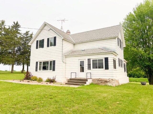 4365 40th St SW, Marysville Twp, MN 55390 - rear view of property featuring a yard, roof with shingles, and a chimney