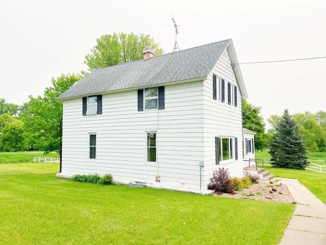 4365 40th St SW, Marysville Twp, MN 55390 - view of side of home featuring a shingled roof, a lawn, and a chimney