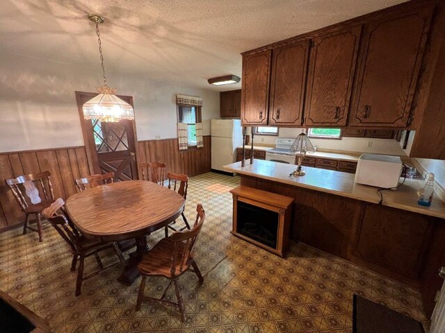 4365 40th St SW, Marysville Twp, MN 55390 - dining room with a wainscoted wall, wooden walls, a textured ceiling, and dark flooring