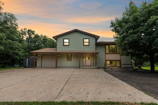 24345 165th St NW, Orrock Twp, MN 55309 - split level home with a garage, covered porch, concrete driveway, and a storage unit