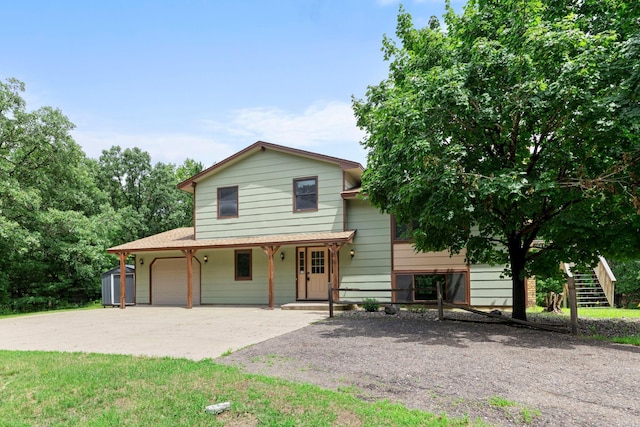 24345 165th St NW, Orrock Twp, MN 55309 - view of front facade with concrete driveway, a storage shed, an attached garage, and covered porch
