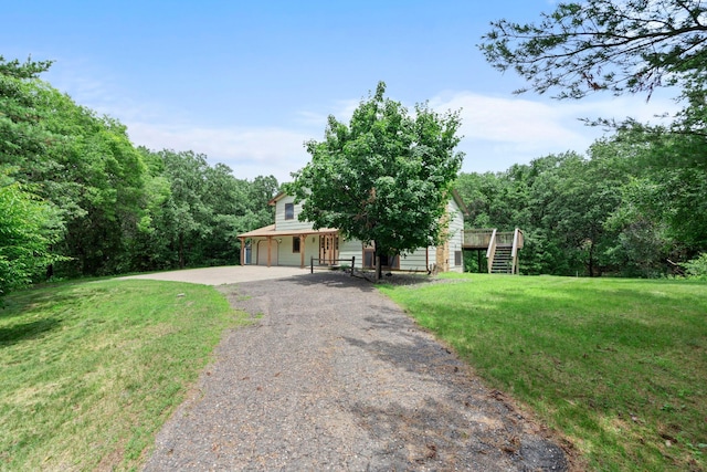 24345 165th St NW, Orrock Twp, MN 55309 - obstructed view of property featuring gravel driveway, stairs, and a front lawn
