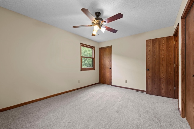 24345 165th St NW, Orrock Twp, MN 55309 - unfurnished bedroom with light carpet, a textured ceiling, and ceiling fan