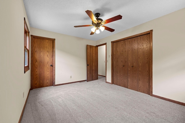 24345 165th St NW, Orrock Twp, MN 55309 - unfurnished bedroom with light carpet, a closet, ceiling fan, and a textured ceiling