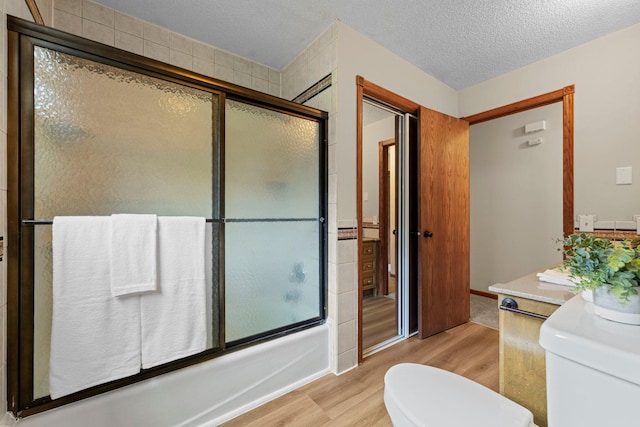 24345 165th St NW, Orrock Twp, MN 55309 - bathroom with wood finished floors, combined bath / shower with glass door, and vanity