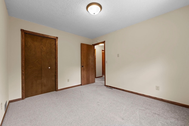 24345 165th St NW, Orrock Twp, MN 55309 - unfurnished bedroom featuring light colored carpet, a textured ceiling, and a closet