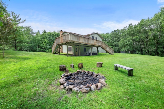 24345 165th St NW, Orrock Twp, MN 55309 - view of green lawn featuring stairway, an outdoor fire pit, a deck, and a wooded view