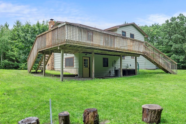 24345 165th St NW, Orrock Twp, MN 55309 - rear view of property featuring stairs, a yard, a wooden deck, and a chimney