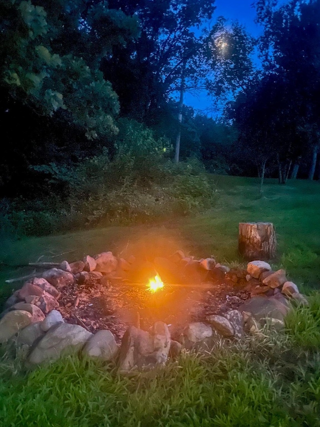 24345 165th St NW, Orrock Twp, MN 55309 - view of grassy yard featuring a fire pit