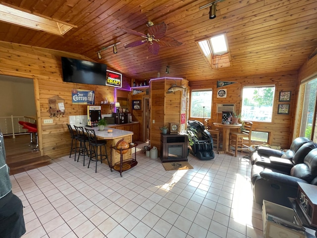 718 22nd St NW, Bemidji, MN 56601 - kitchen with vaulted ceiling, wooden walls, rail lighting, plenty of natural light, and tile patterned floors