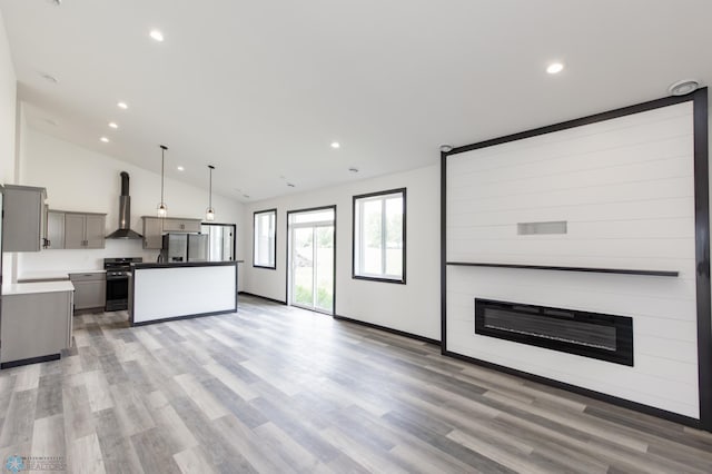 4712 Hampton Loop S, Moorhead, MN 56560 - kitchen with stainless steel appliances, wall chimney range hood, open floor plan, gray cabinetry, and recessed lighting