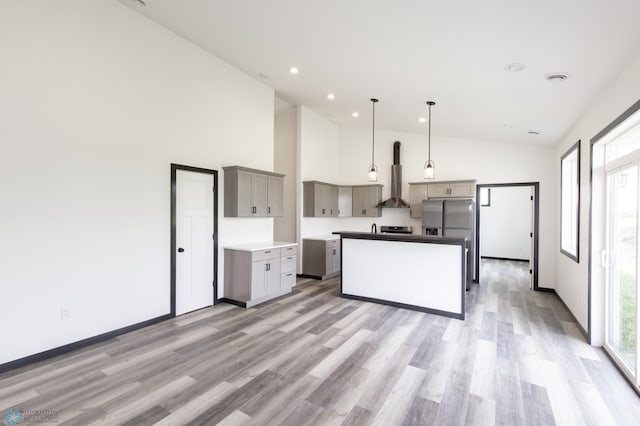 4712 Hampton Loop S, Moorhead, MN 56560 - kitchen with wall chimney exhaust hood, gray cabinetry, stainless steel refrigerator with ice dispenser, light wood finished floors, and a center island
