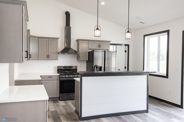 4712 Hampton Loop S, Moorhead, MN 56560 - kitchen with stainless steel appliances, gray cabinets, ventilation hood, light wood-style flooring, and vaulted ceiling