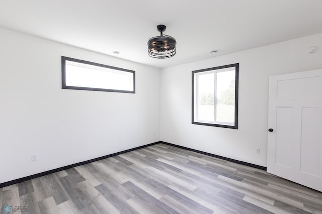 4712 Hampton Loop S, Moorhead, MN 56560 - unfurnished room featuring healthy amount of natural light, light wood finished floors, and baseboards