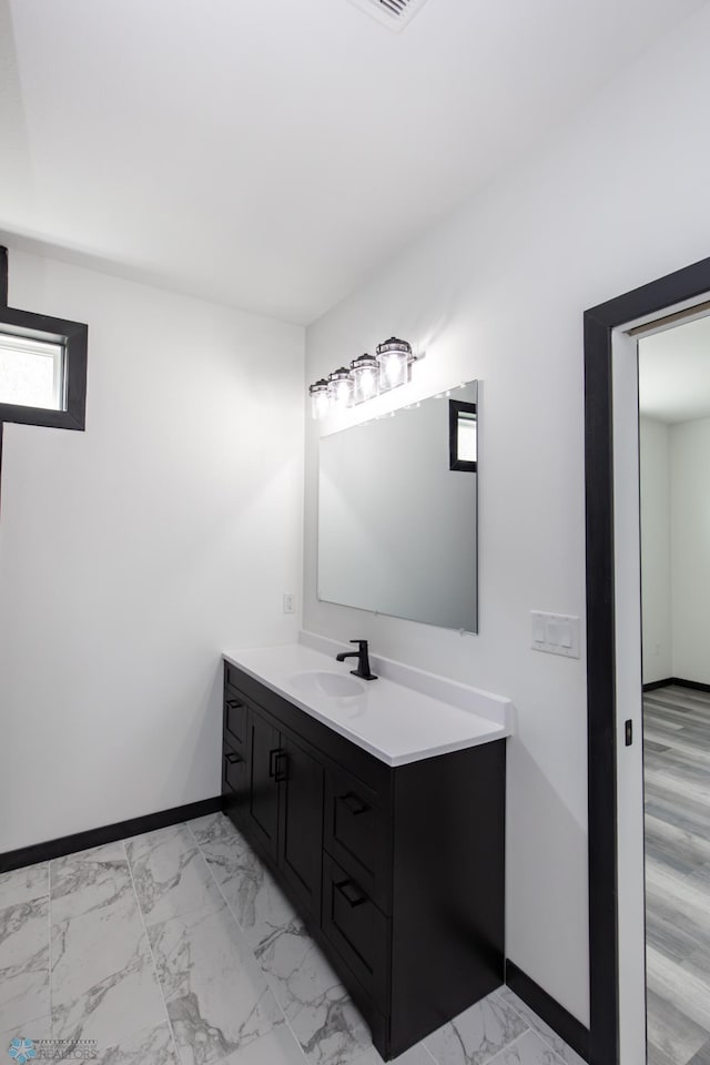 4712 Hampton Loop S, Moorhead, MN 56560 - bathroom with vanity, marble look tile flooring, and baseboards