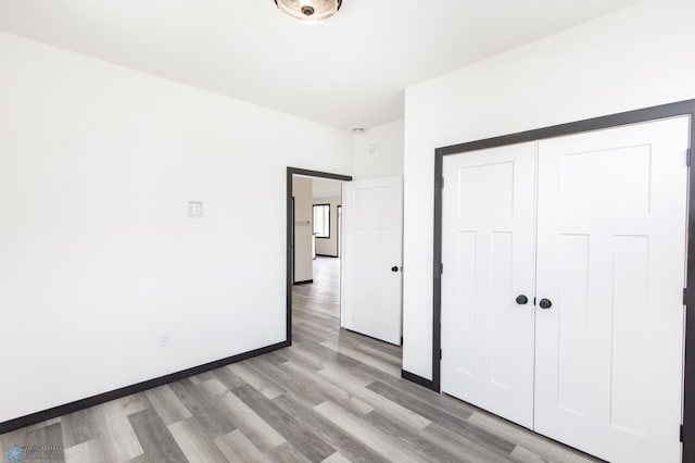 4712 Hampton Loop S, Moorhead, MN 56560 - unfurnished bedroom featuring light wood-style floors, a closet, and baseboards