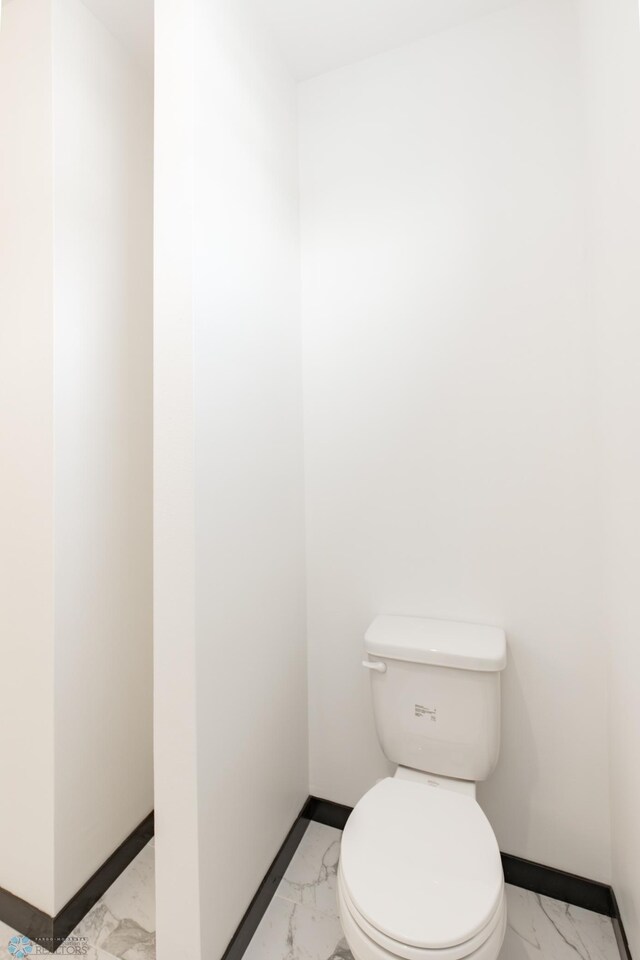 4712 Hampton Loop S, Moorhead, MN 56560 - bathroom with marble look tiles, baseboards, and toilet