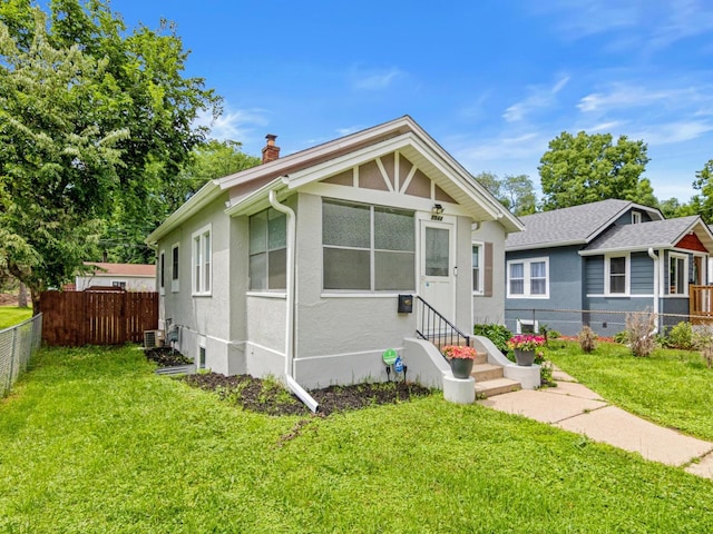3944 Clinton Ave, Minneapolis, MN 55409 - bungalow featuring a chimney and stucco siding