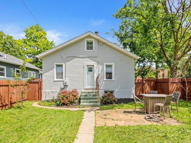 3944 Clinton Ave, Minneapolis, MN 55409 - rear view of property featuring stucco siding, a fenced backyard, and a patio area