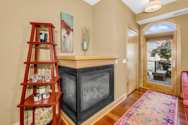 650 Main St N Unit B05, Stillwater, MN 55082 - entrance foyer with wood finished floors, a multi sided fireplace, and baseboards
