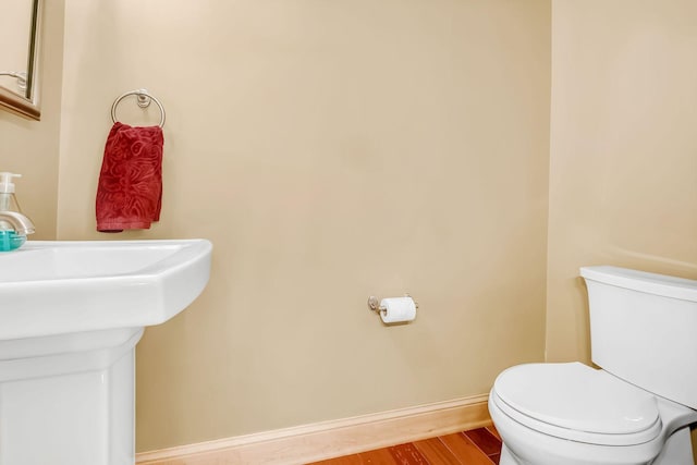 650 Main St N Unit B05, Stillwater, MN 55082 - bathroom featuring toilet, wood finished floors, and baseboards