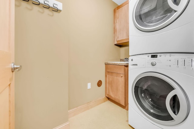 650 Main St N Unit B05, Stillwater, MN 55082 - washroom with stacked washer / drying machine and cabinet space