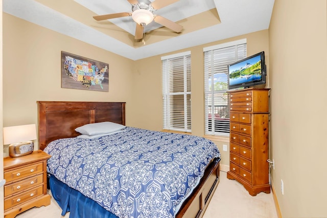650 Main St N Unit B05, Stillwater, MN 55082 - bedroom featuring light colored carpet, a tray ceiling, and ceiling fan
