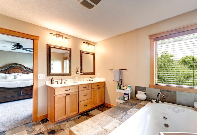 462 Rowena Curv, Elko New Market, MN 55054 - full bathroom with ensuite bath, stone tile floors, double vanity, a jetted tub, and ceiling fan