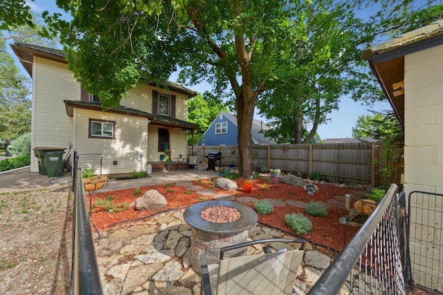 721 1st St N, Waterville, MN 56096 - back of house with a patio area, an outdoor fire pit, and a fenced backyard