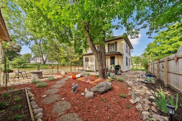 721 1st St N, Waterville, MN 56096 - back of property with a fenced backyard and a patio