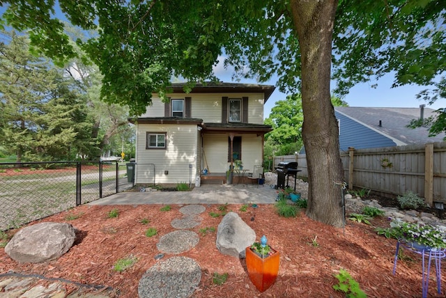 721 1st St N, Waterville, MN 56096 - rear view of house with a fenced backyard, a gate, and a patio area