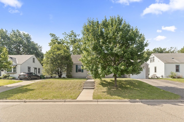 5107 Corvallis Ave N, Crystal, MN 55429 - view of front of home featuring concrete driveway, a front yard, and a garage