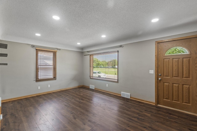 5107 Corvallis Ave N, Crystal, MN 55429 - entrance foyer with a textured ceiling, recessed lighting, dark wood-type flooring, and baseboards