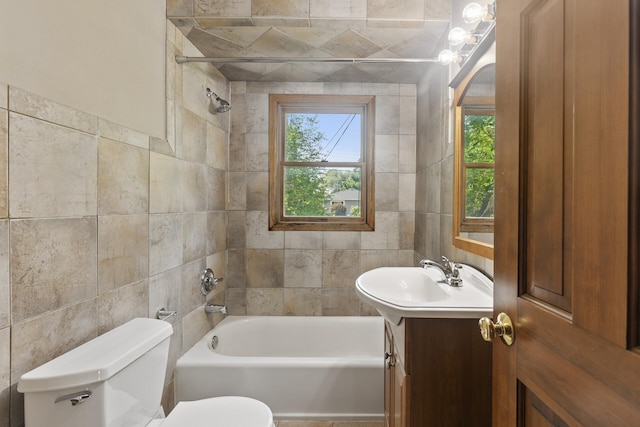 5107 Corvallis Ave N, Crystal, MN 55429 - bathroom featuring tile walls, toilet, vanity, and shower / bath combination