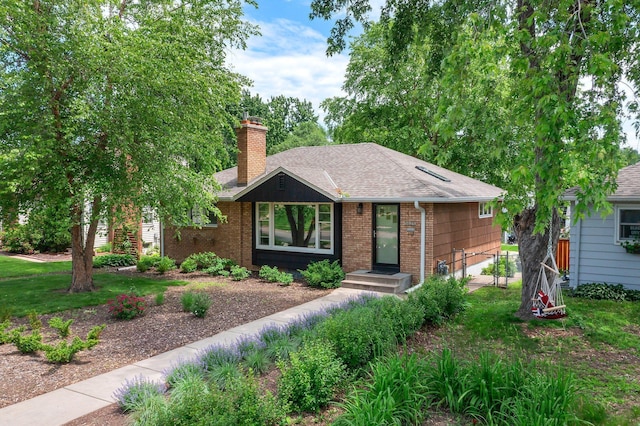 5625 Upton Ave S, Minneapolis, MN 55410 - ranch-style home featuring a chimney, roof with shingles, and brick siding
