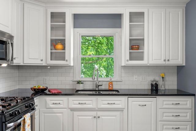 5625 Upton Ave S, Minneapolis, MN 55410 - kitchen featuring stainless steel appliances, white cabinetry, and tasteful backsplash