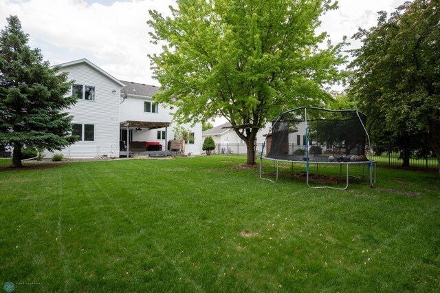 4408 Riverwood Dr N, Fargo, ND 58102 - view of yard with a trampoline and a patio
